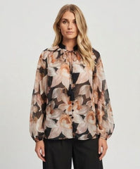 Yours Truly Floral Blouse in Black - model wearing black floral blouse with tassel tie neckline